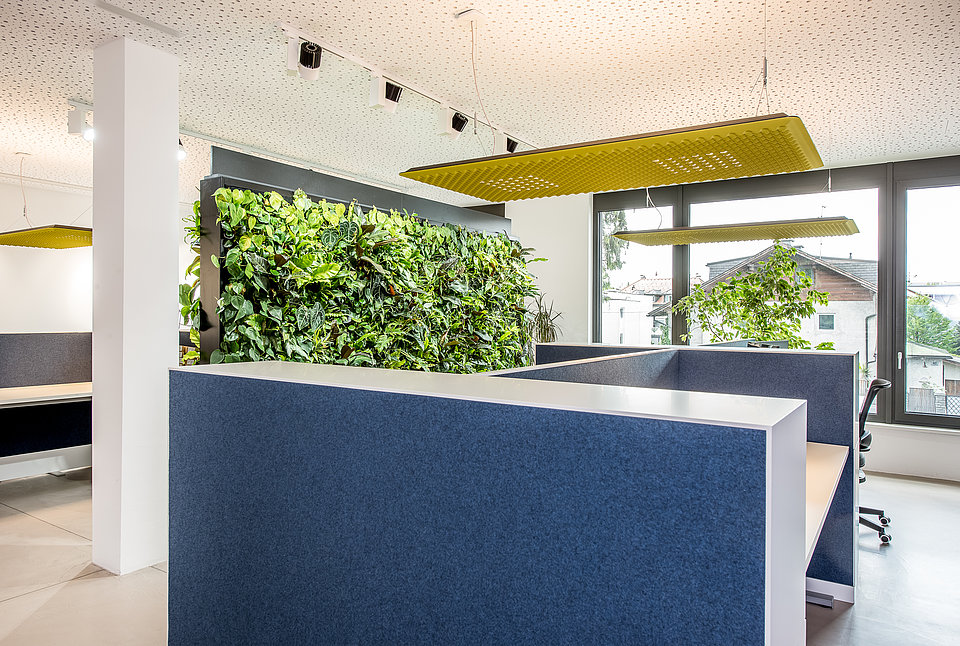 Büro mit Arbeitsbereichen und gelber Deckenleuchte